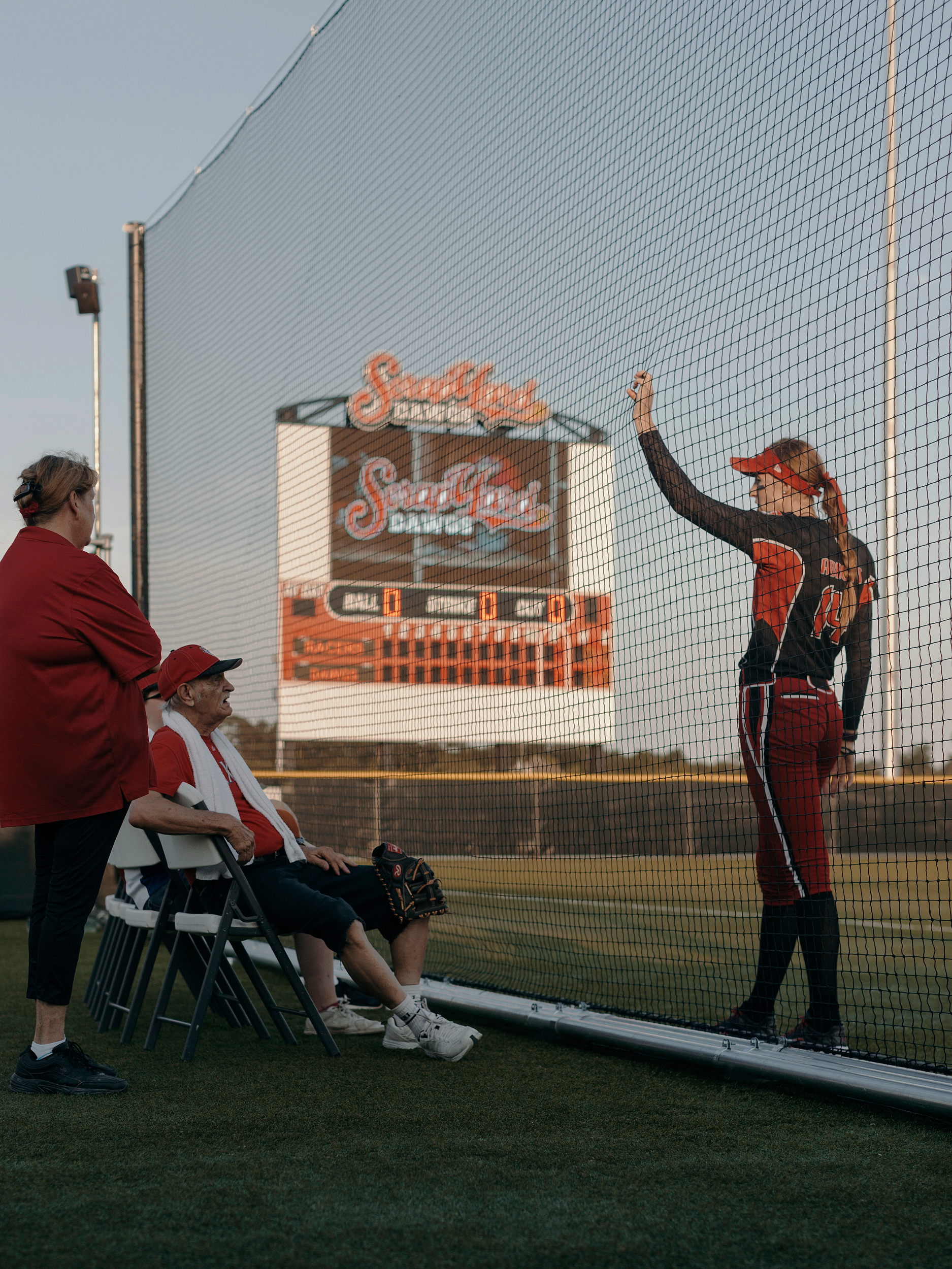 Pitcher, Monica Abbott, talks with elderly fans before the game. Todd Spoth for The New York Times.