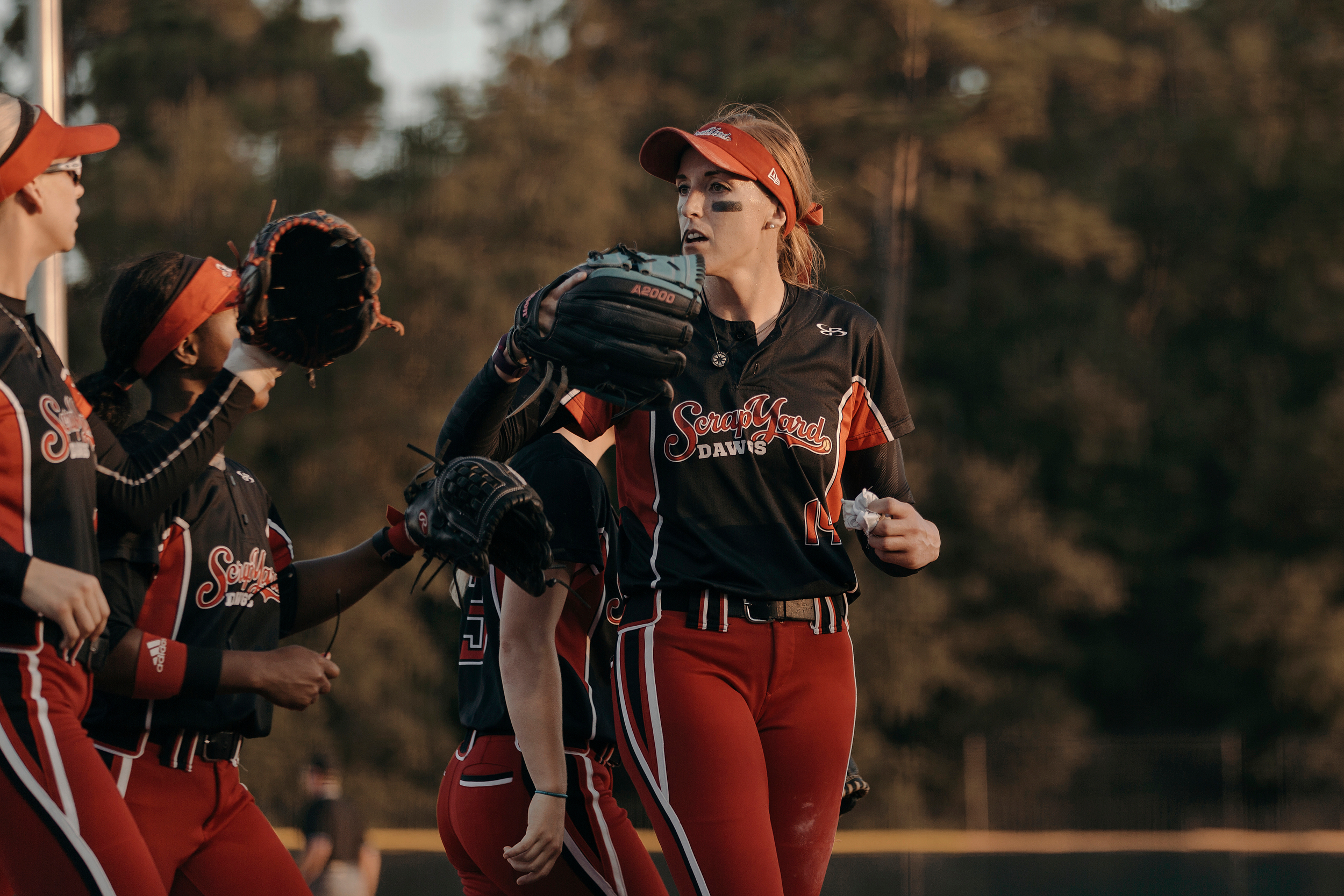 Pitcher, Monica Abbott, congratulates teammates following a play. The Scrap Yard Dawgs won the game 1-0. Todd Spoth for The New York Times.