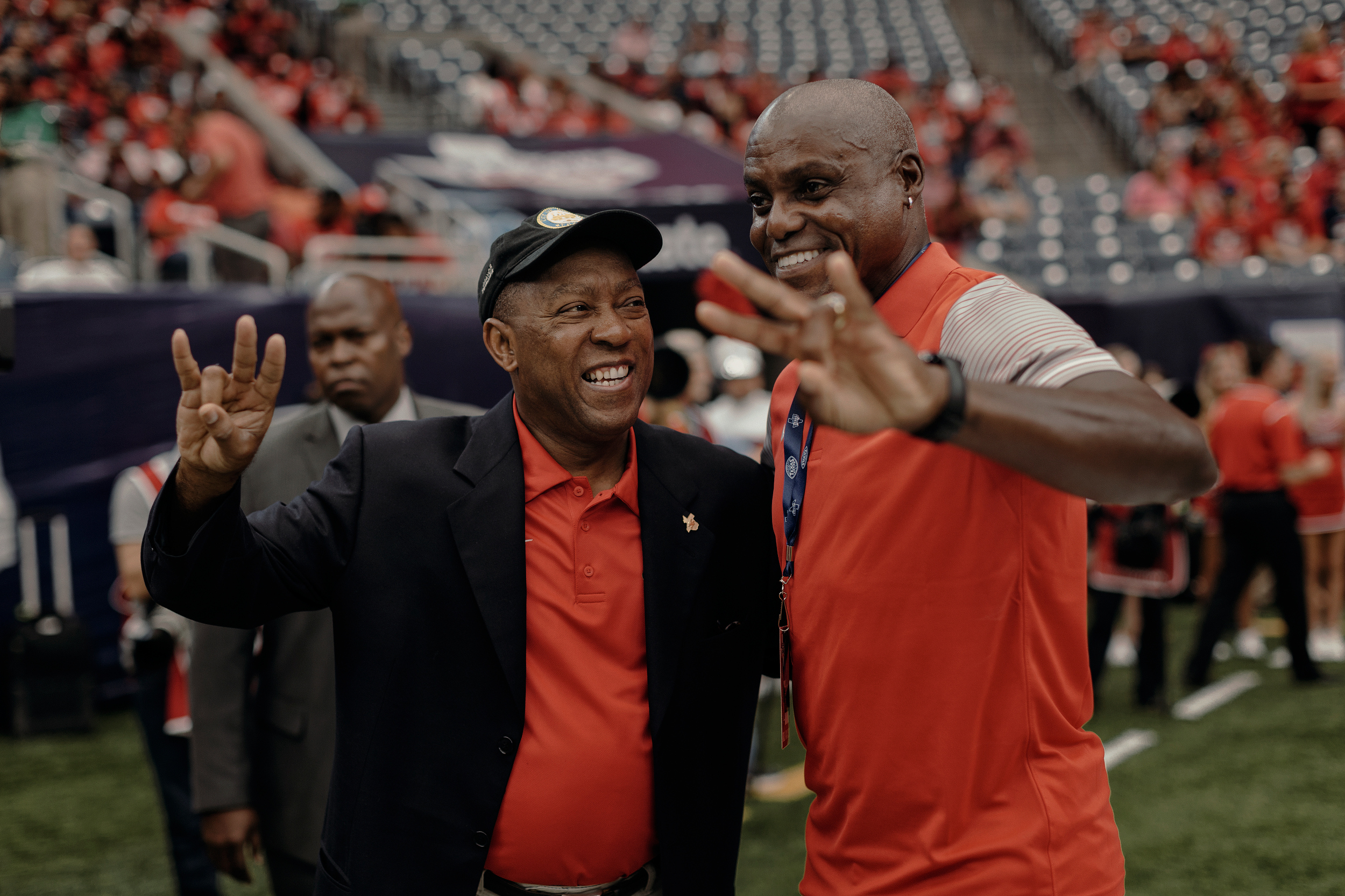 Houston mayor, Sylvester Turner smiles at former US olympian and University of Houston graduate, Carl Lewis, while both pose for a photo prior to the game. Todd Spoth for The New York Times.