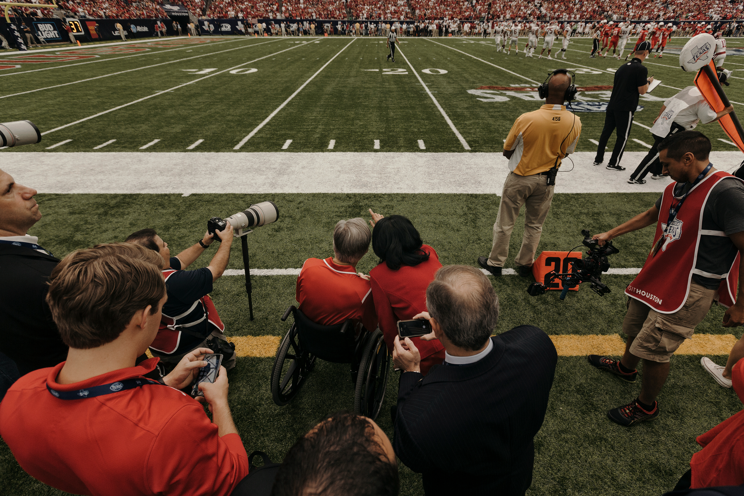 Texas governor Greg Abbott and University of Houston president, Renu Khator, watch the game. Todd Spoth for The New York Times.