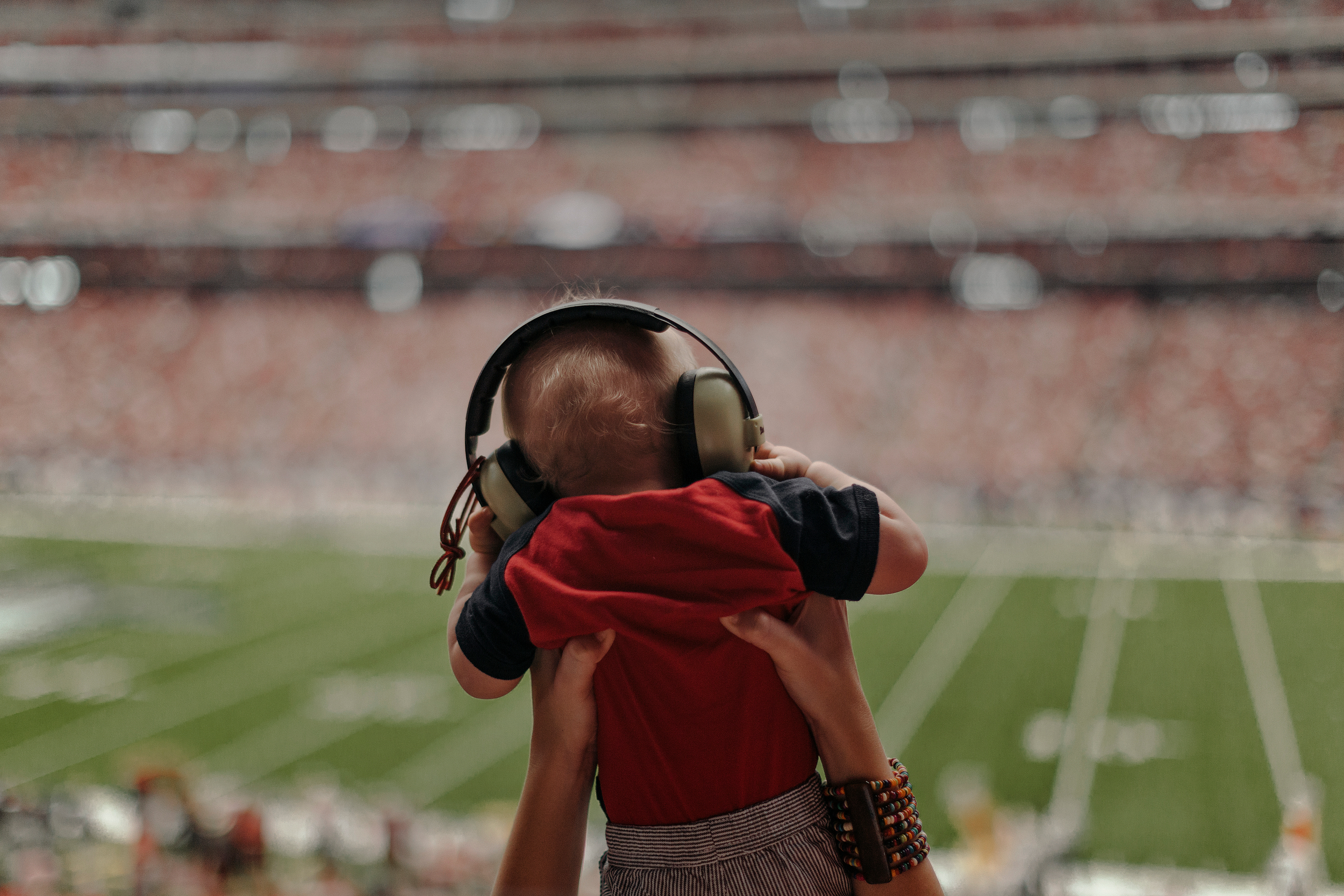 A baby watches the game from his mother's arms. Todd Spoth for The New York Times.